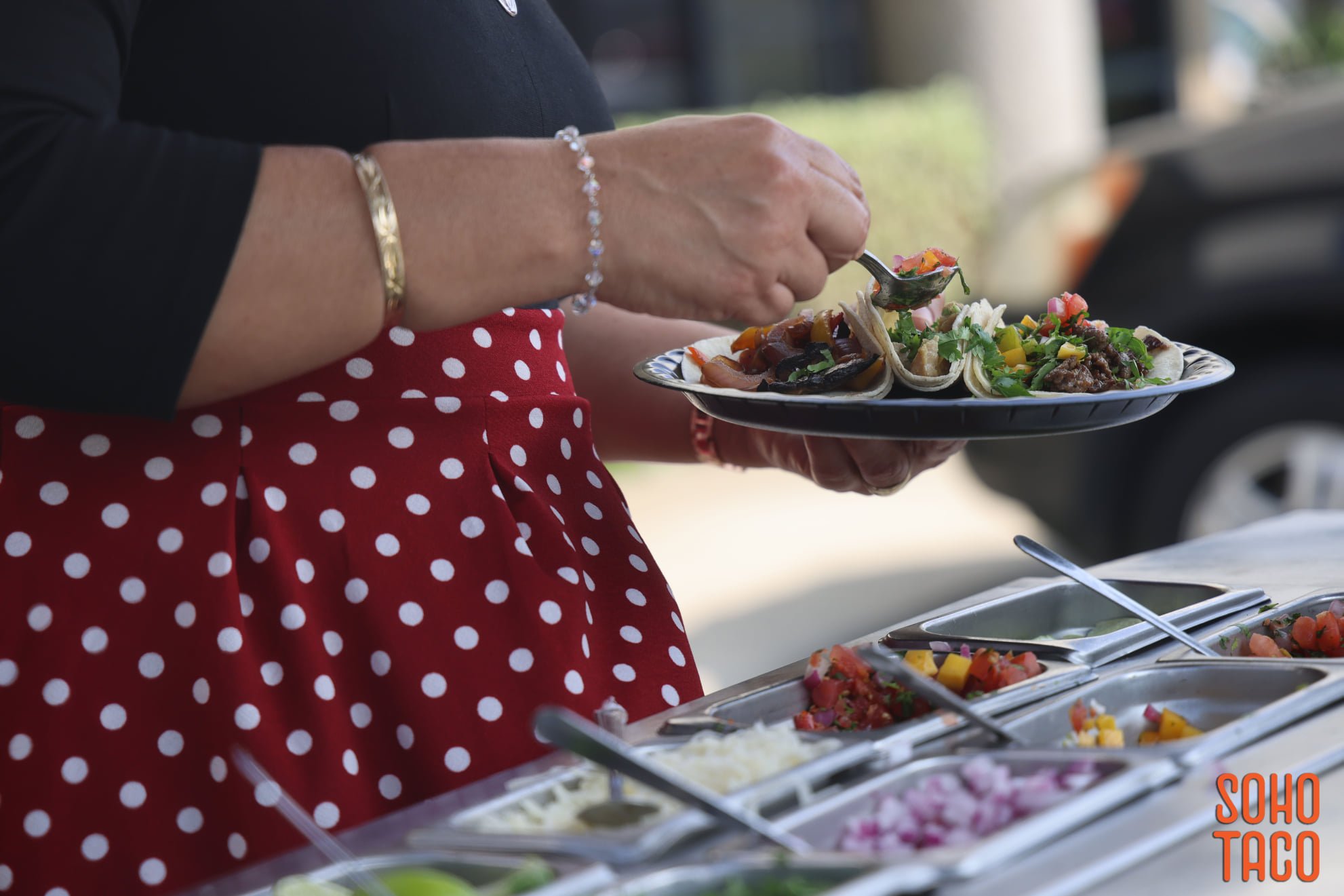 A SOHO TACO catering station being plated for a Southern California event