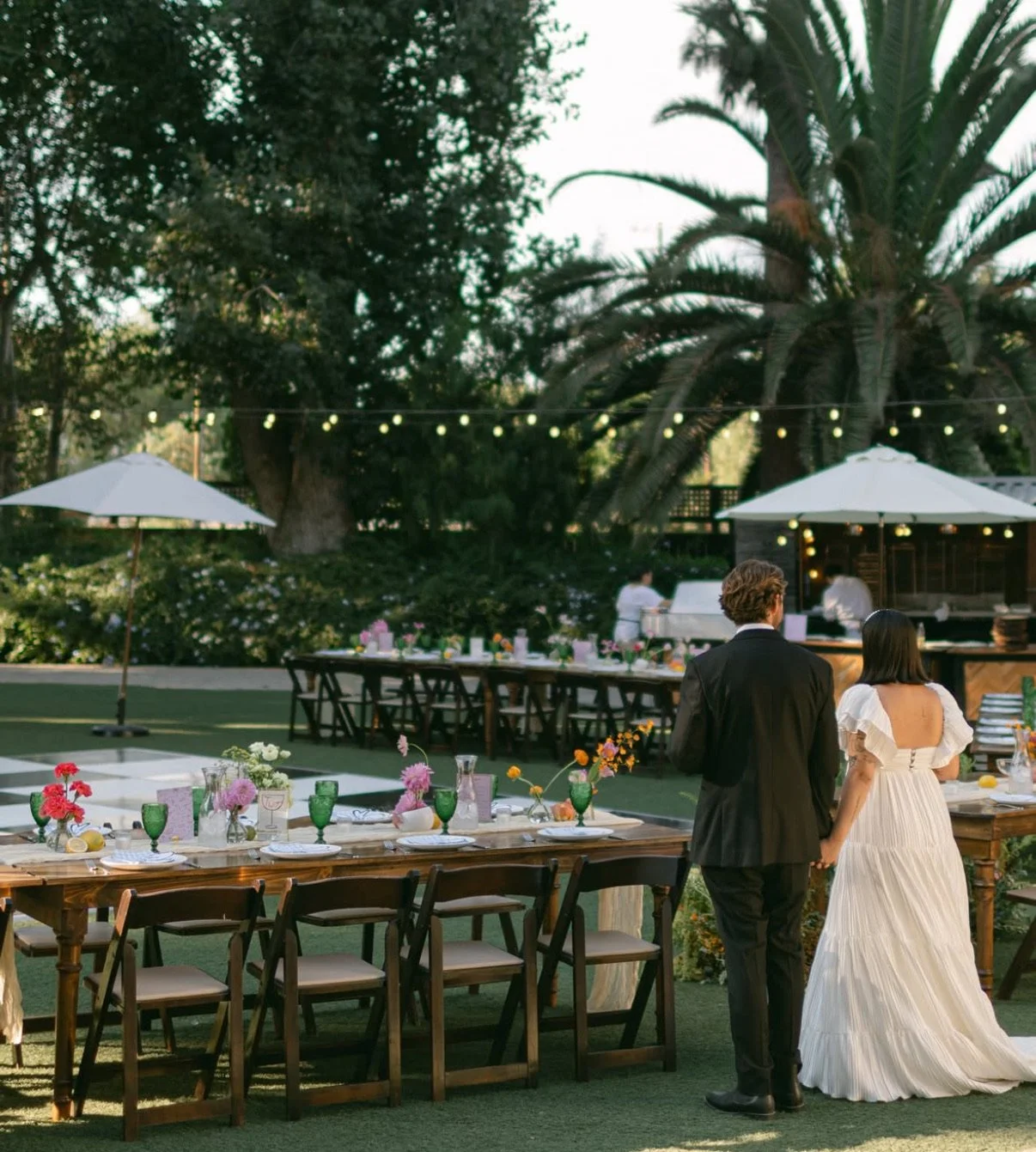 Bride and groom holding hands at their wedding reception at McCormick Home Ranch in Camarillo