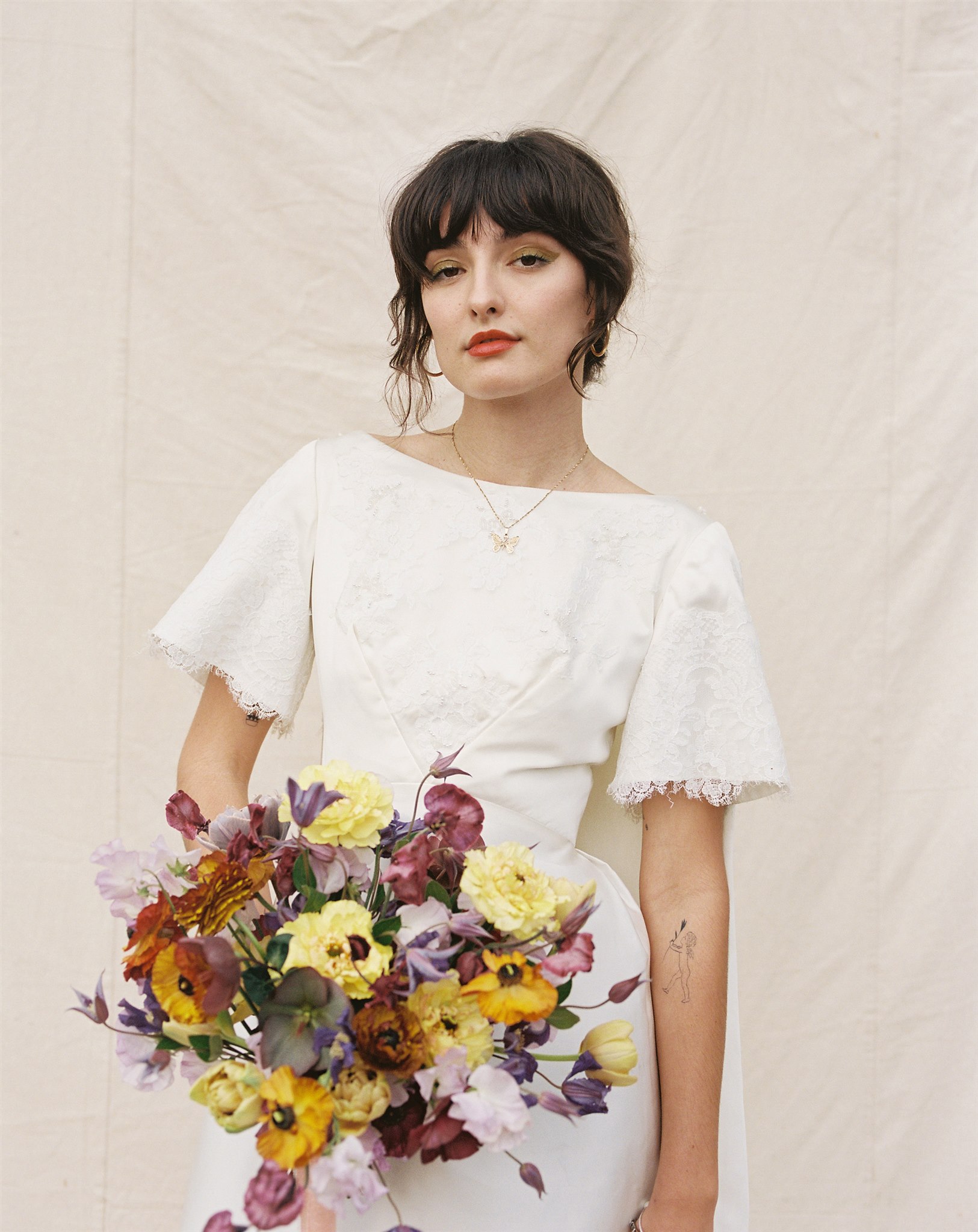 Bride holding a colorful wedding bouquet from Velvet Blooms