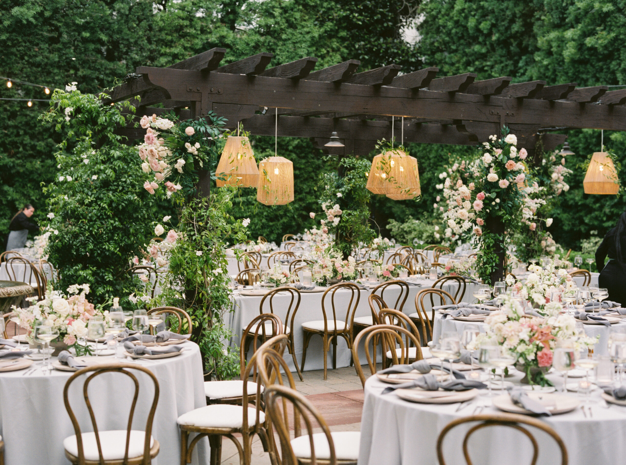 An outdoor wedding reception dinner under string lights, catered by 24 Carrots Catering and Events in Southern California